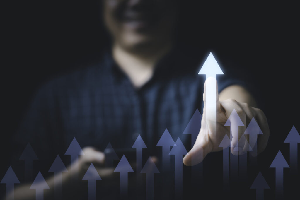 businessman touching to glowing increasing arrow for business pr