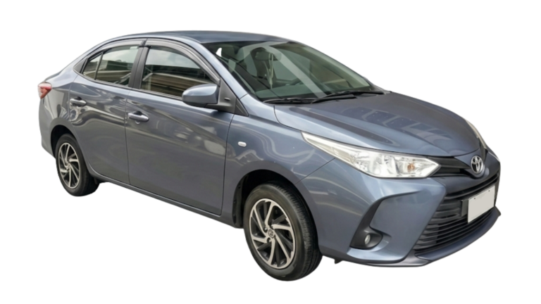 Three-quarter front view of a gray Toyota Vios sedan with alloy wheels and side rain guards, isolated on a white background.